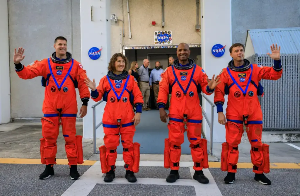Artemis II crew members (from left) CSA (Canadian Space Agency) astronaut Jeremy Hansen, and NASA astronauts Christina Koch, Victor Glover, and Reid Wiseman walk out of Astronaut Crew Quarters inside the Neil Armstrong Operations and Checkout Building to the Artemis crew transportation vehicles prior to traveling to Launch Pad 39B as part of an integrated ground systems test at Kennedy Space Center in Florida on Wednesday, Sept. 20, to test the crew timeline for launch day.
(NASA)